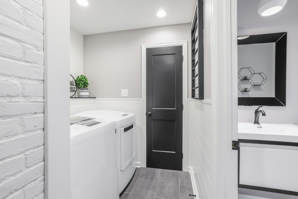 Inspiration for a small transitional single-wall dedicated laundry room in Columbus with shiplap splashback, grey walls, porcelain floors, a side-by-side washer and dryer, grey floor and wallpaper.