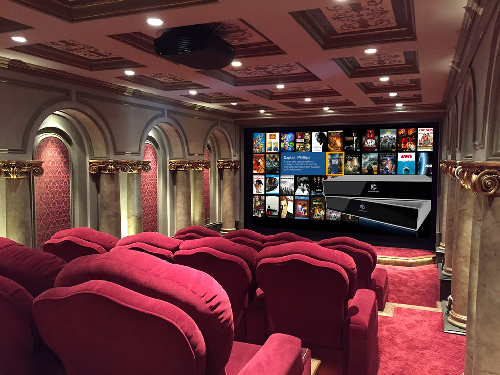 This is an example of an expansive modern enclosed home theatre in Atlanta with red walls, carpet, a projector screen and red floor.