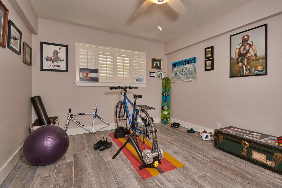 Design ideas for a mid-sized transitional home gym in Austin with grey walls, medium hardwood floors and brown floor.