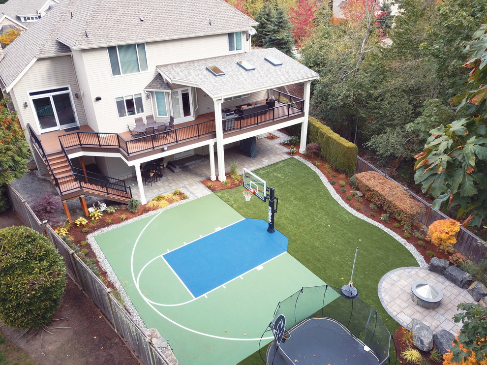 Photo of an expansive modern backyard deck in Seattle with a fire feature.