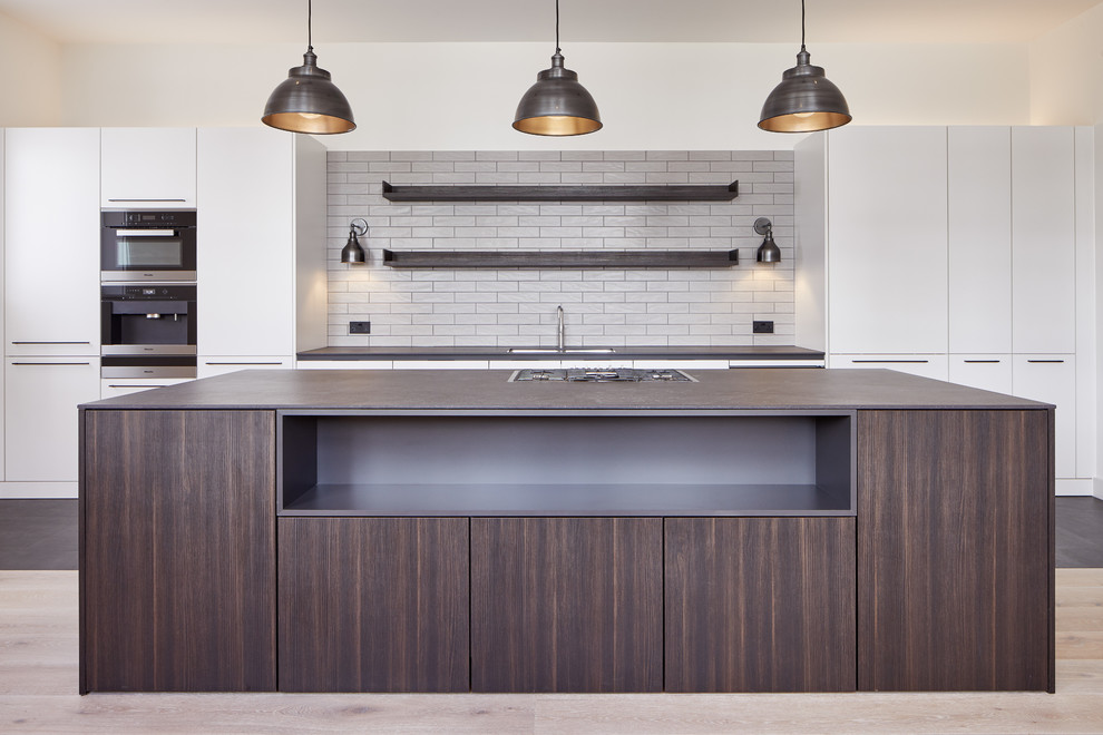 Large modern kitchen in London with light hardwood floors.