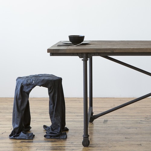 wood dining table with metal legs and jeans covered backless stool