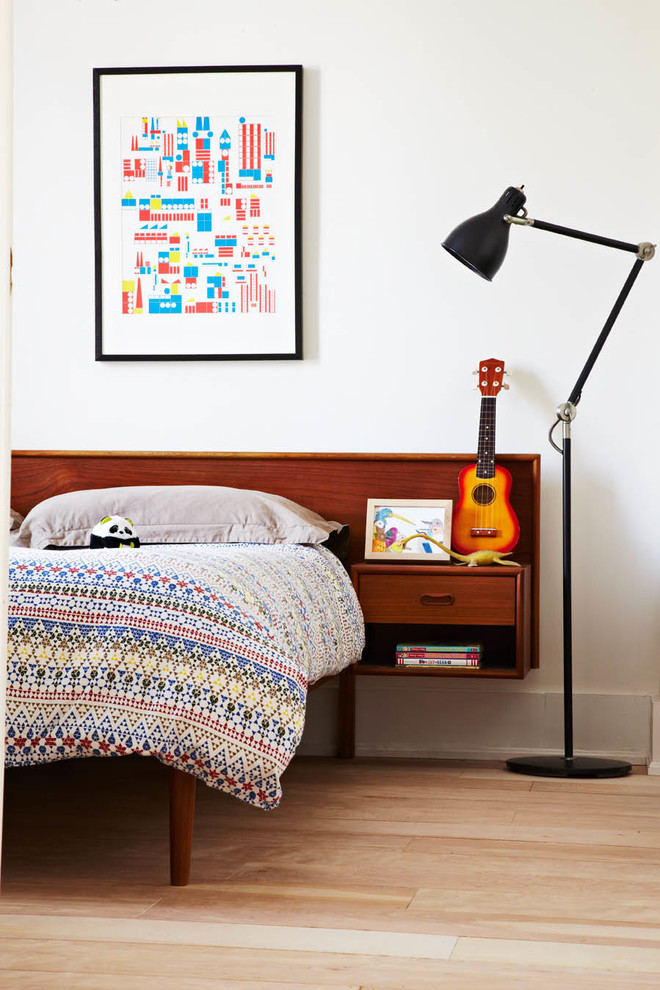 Inspiration for an eclectic bedroom in Toronto with white walls and light hardwood floors.