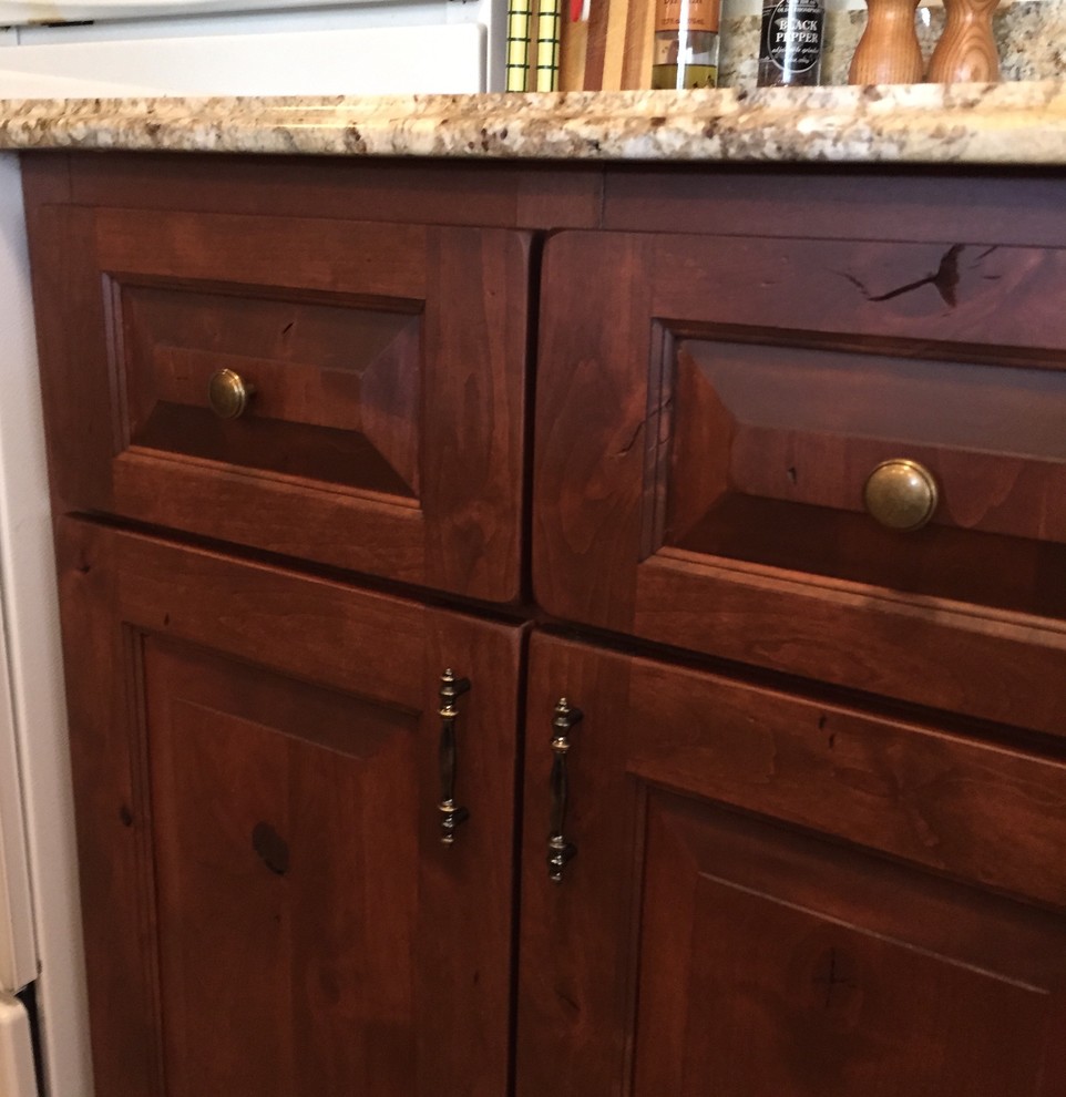 Home design - small rustic u-shaped ceramic tile home design idea in Denver with an undermount sink, shaker cabinets, medium tone wood cabinets, granite countertops, beige backsplash, white appliances and no island