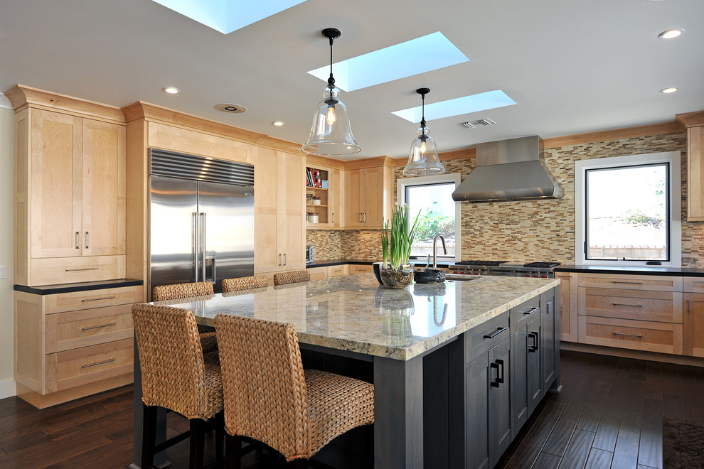 Inspiration for a mid-sized transitional u-shaped dark wood floor open concept kitchen remodel in Los Angeles with a farmhouse sink, shaker cabinets, light wood cabinets, granite countertops, multicolored backsplash, stainless steel appliances, beige walls and an island