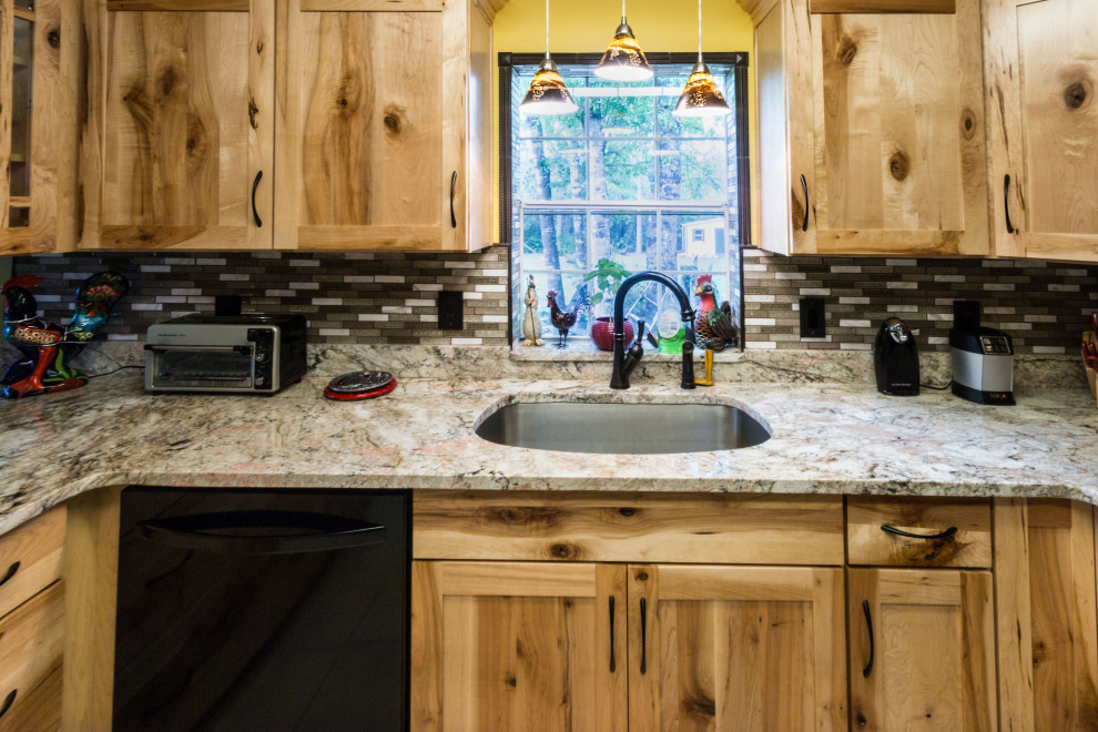 Example of a mid-sized u-shaped cement tile floor and beige floor eat-in kitchen design with an undermount sink, shaker cabinets, light wood cabinets, granite countertops, glass tile backsplash, black appliances, a peninsula and beige countertops