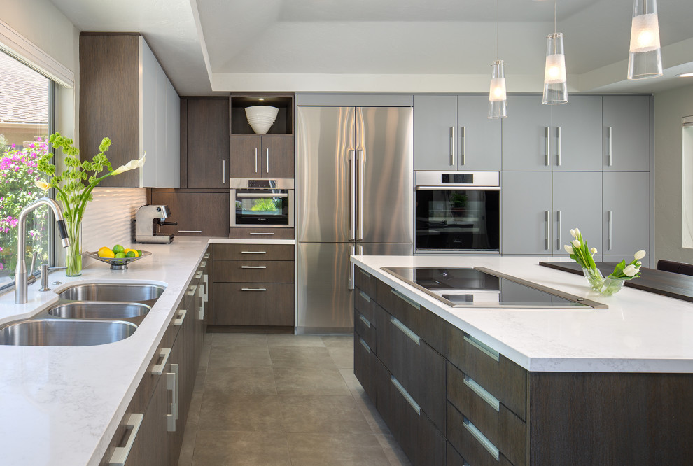 Large contemporary u-shaped eat-in kitchen in San Diego with a triple-bowl sink, flat-panel cabinets, dark wood cabinets, marble benchtops, white splashback, ceramic splashback, stainless steel appliances, ceramic floors, with island, multi-coloured floor, white benchtop and coffered.