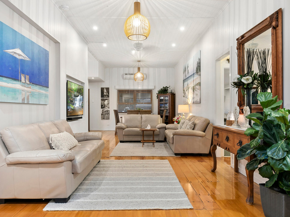 Photo of a contemporary open concept living room in Brisbane with white walls, light hardwood floors and a wall-mounted tv.