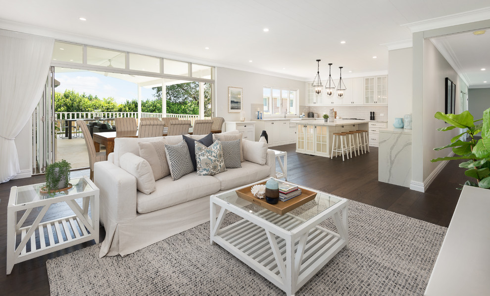 Inspiration for a large beach style open concept living room in Sydney with grey walls, dark hardwood floors and a freestanding tv.