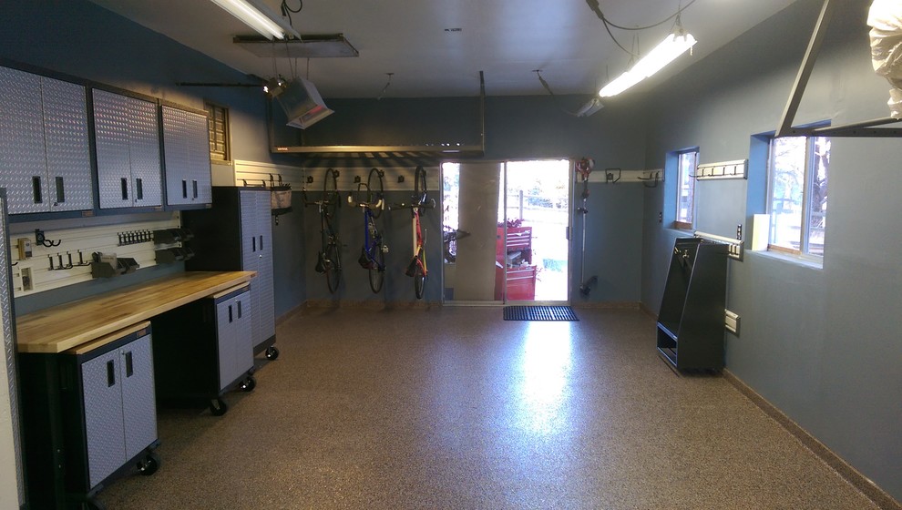 Mid-sized transitional attached two-car garage workshop photo in Denver