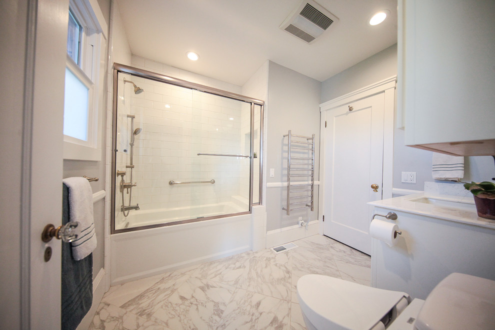 Mid-sized traditional master bathroom in San Francisco with recessed-panel cabinets, white cabinets, a drop-in tub, a shower/bathtub combo, a bidet, white tile, white walls, linoleum floors and a pedestal sink.