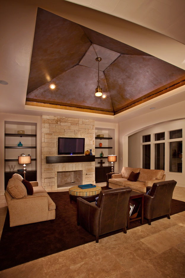 Design ideas for a contemporary open concept family room in Albuquerque with beige walls, a standard fireplace, a stone fireplace surround and a wall-mounted tv.