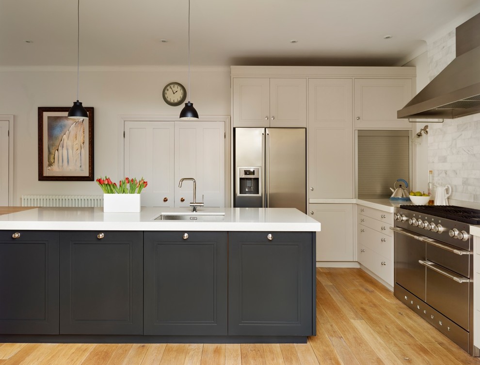 Mid-sized traditional kitchen in London with shaker cabinets and with island.