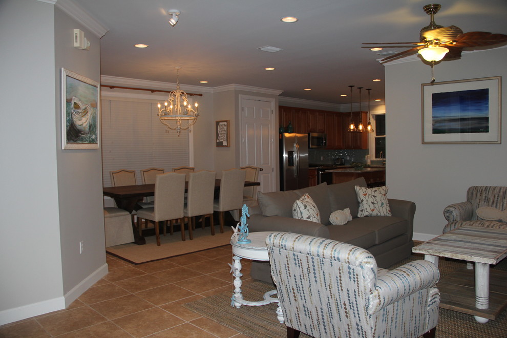 This is an example of a beach style open concept family room in Miami with grey walls and ceramic floors.