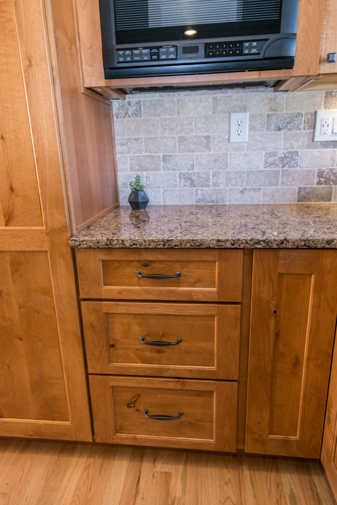 Eat-in kitchen - mid-sized rustic galley medium tone wood floor and brown floor eat-in kitchen idea in Denver with an undermount sink, shaker cabinets, medium tone wood cabinets, quartz countertops, gray backsplash, stone tile backsplash, black appliances, no island and brown countertops