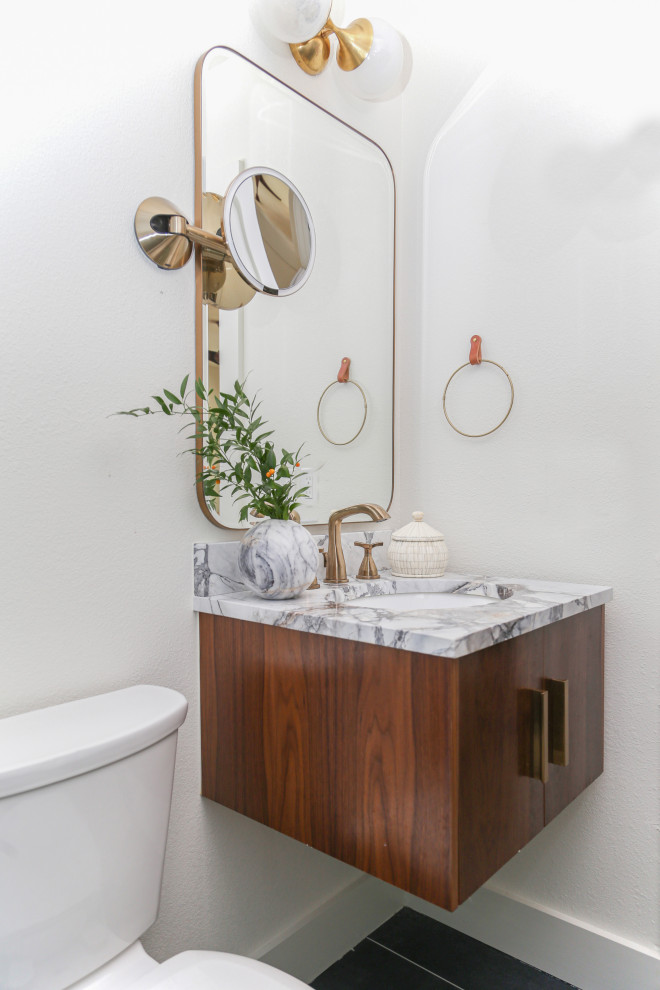 This is an example of a mid-sized midcentury bathroom in Other with flat-panel cabinets, dark wood cabinets, an alcove shower, a one-piece toilet, white tile, white walls, porcelain floors, with a sauna, an undermount sink, marble benchtops, blue floor, a hinged shower door, white benchtops, a shower seat, a single vanity and a floating vanity.