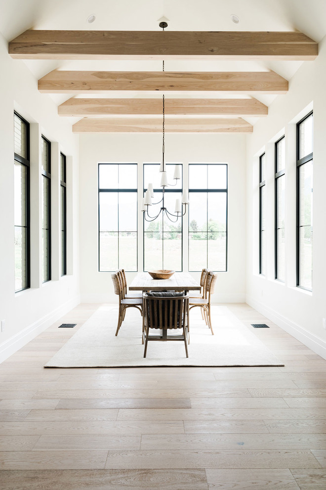 This is an example of a mid-sized beach style dining room in Salt Lake City with white walls and light hardwood floors.