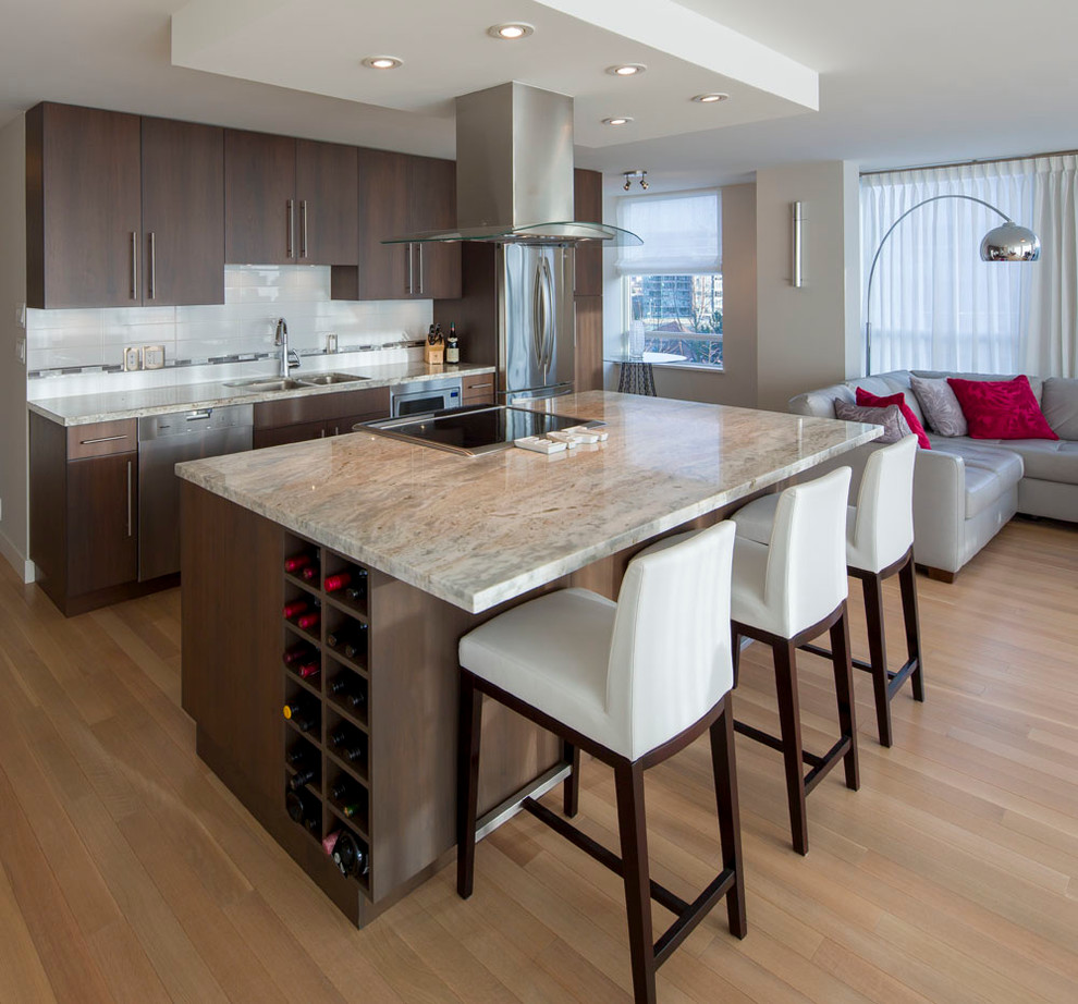 Mid-sized contemporary single-wall open plan kitchen in Vancouver with a double-bowl sink, flat-panel cabinets, medium wood cabinets, granite benchtops, stainless steel appliances, with island, white splashback, subway tile splashback, light hardwood floors and beige floor.