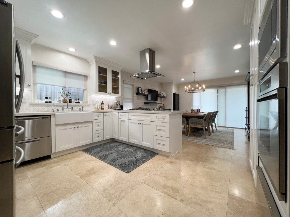 Eat-in kitchen - huge modern l-shaped ceramic tile and beige floor eat-in kitchen idea in Orange County with a farmhouse sink, shaker cabinets, white cabinets, quartzite countertops, gray backsplash, ceramic backsplash, stainless steel appliances, a peninsula and white countertops