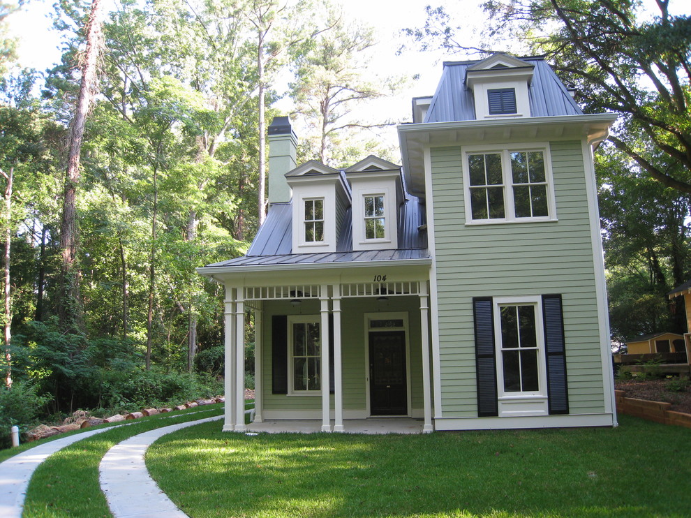 Design ideas for a mid-sized victorian two-storey grey house exterior in Atlanta with vinyl siding, a hip roof and a metal roof.