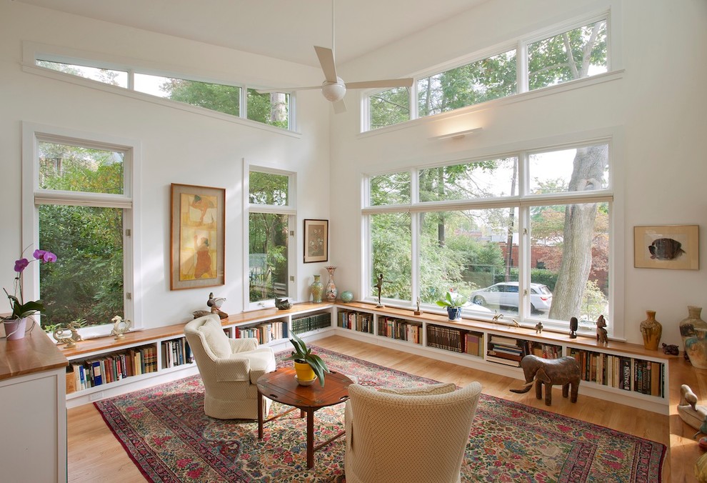 Inspiration for a transitional living room in DC Metro with a library and light hardwood floors.