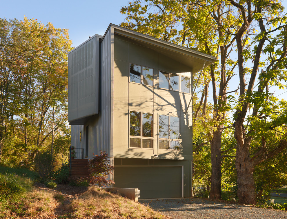 Mid-sized trendy gray three-story concrete fiberboard house exterior photo with a shed roof and a metal roof