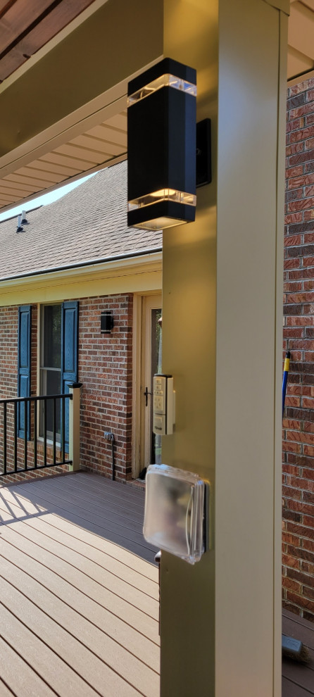 Inspiration for a contemporary ground level metal railing deck remodel with a roof extension