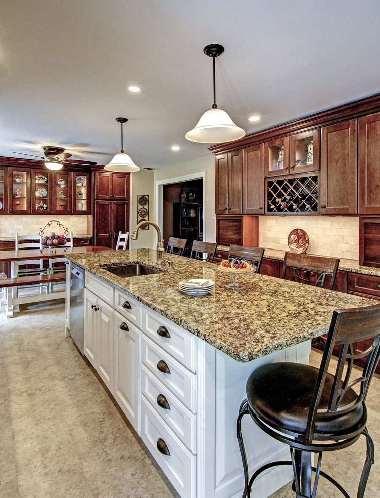 This is an example of a large traditional u-shaped eat-in kitchen in Philadelphia with a single-bowl sink, recessed-panel cabinets, medium wood cabinets, granite benchtops, beige splashback, marble splashback, stainless steel appliances, vinyl floors, with island, multi-coloured floor and beige benchtop.