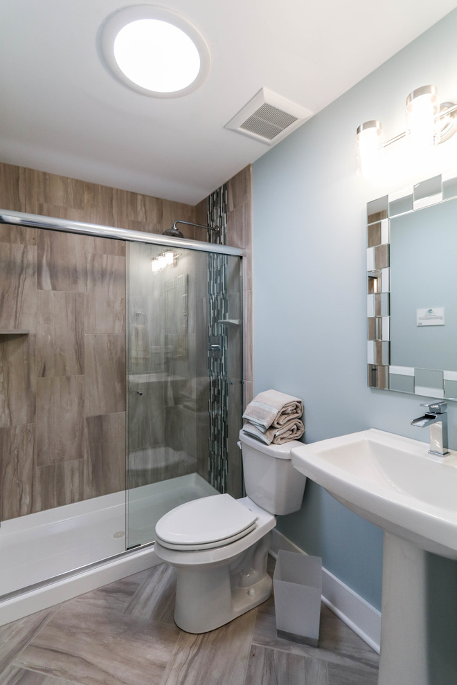 Design ideas for a mid-sized country kids bathroom in Chicago with a corner shower, gray tile, ceramic tile, blue walls, ceramic floors, a pedestal sink, grey floor and a sliding shower screen.