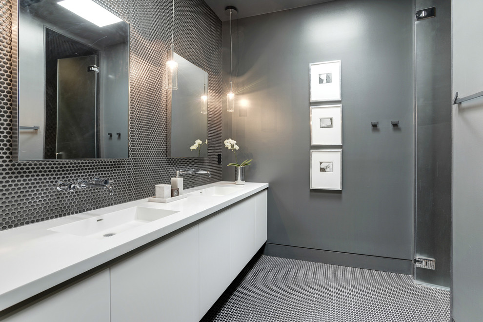 Inspiration for a contemporary bathroom in DC Metro with flat-panel cabinets, white cabinets, an alcove tub, a corner shower, porcelain tile, grey walls, an integrated sink, solid surface benchtops, black floor, a hinged shower door and white benchtops.
