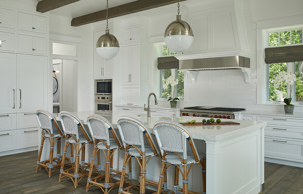 Eat-in kitchen - transitional eat-in kitchen idea with a farmhouse sink, shaker cabinets, white cabinets, limestone countertops, stainless steel appliances, an island and white countertops