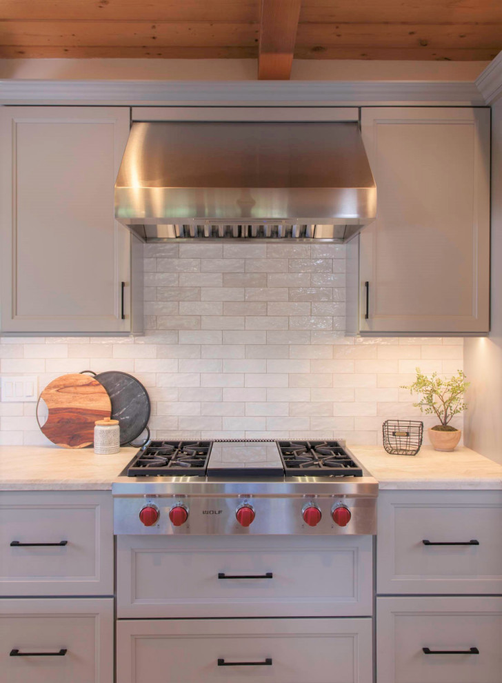 Example of a large mountain style galley porcelain tile, gray floor and wood ceiling open concept kitchen design in Denver with an undermount sink, recessed-panel cabinets, gray cabinets, quartzite countertops, white backsplash, cement tile backsplash, stainless steel appliances, an island and white countertops
