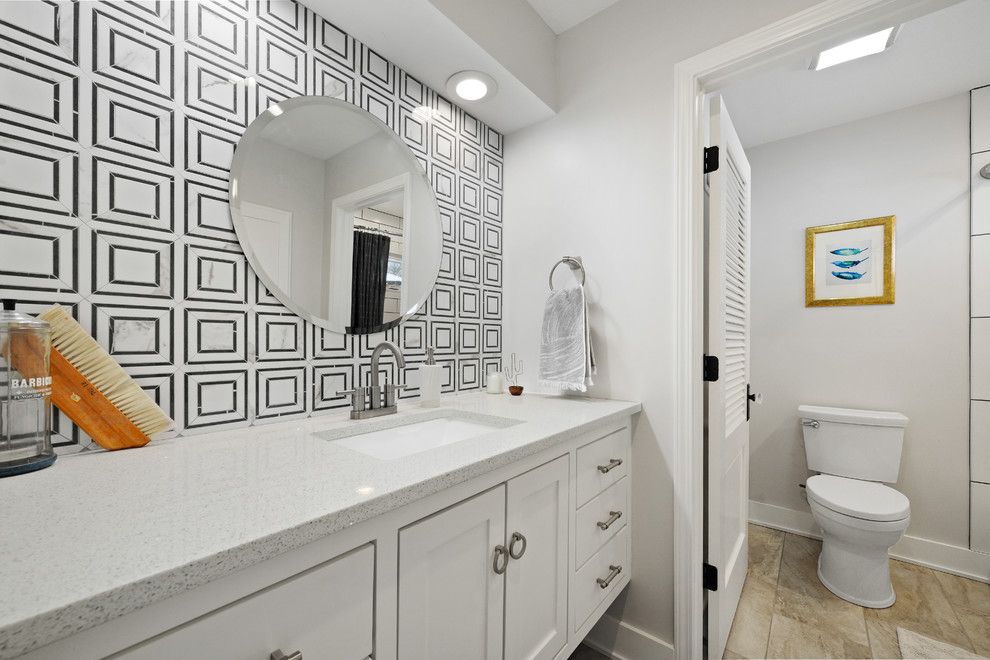 This is an example of a small traditional bathroom in Kansas City with recessed-panel cabinets, white cabinets, an alcove tub, a shower/bathtub combo, white tile, glass tile, white walls, an undermount sink, a shower curtain and white benchtops.