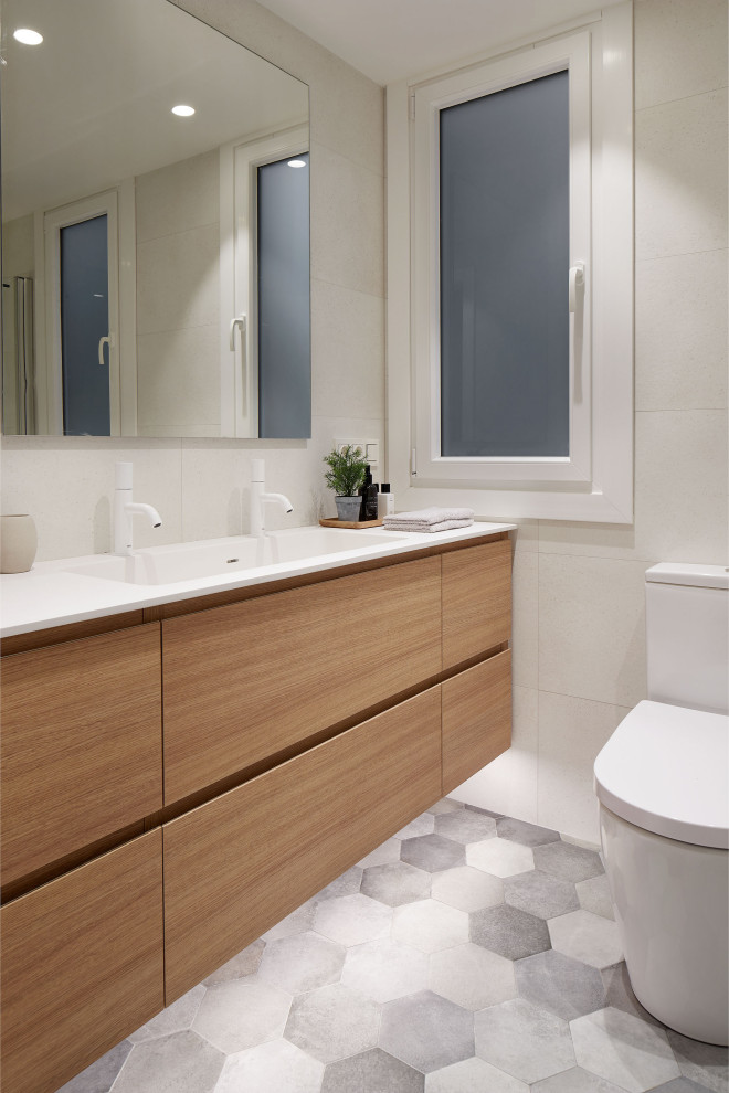 This is an example of a mid-sized modern 3/4 bathroom in Other with flat-panel cabinets, white cabinets, a curbless shower, white tile, ceramic tile, solid surface benchtops, pink floor, a hinged shower door, white benchtops, an enclosed toilet, a single vanity and a floating vanity.