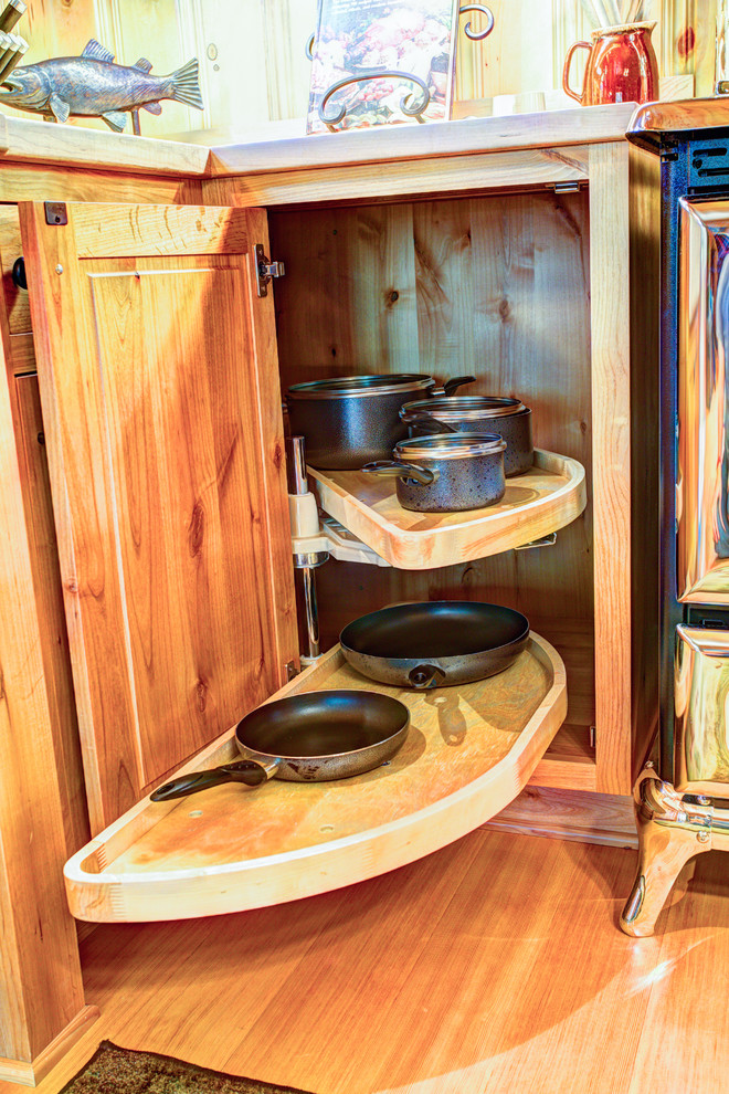 Inspiration for a mid-sized rustic l-shaped light wood floor eat-in kitchen remodel with a farmhouse sink, beaded inset cabinets, light wood cabinets, wood countertops, stainless steel appliances and no island