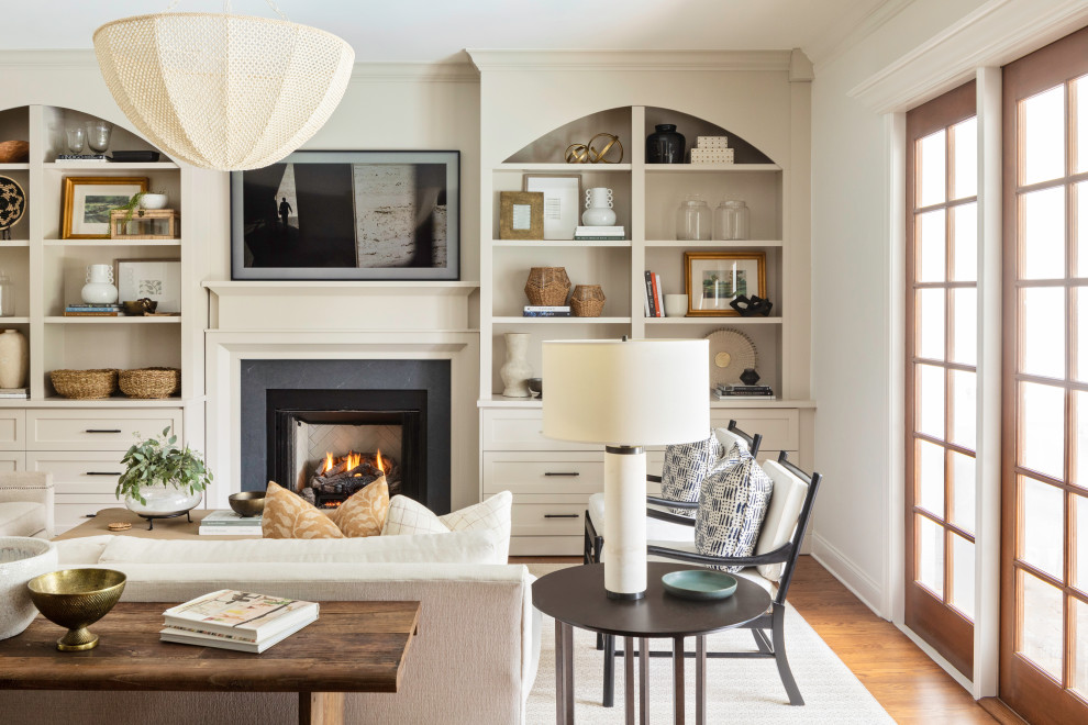 Family room - large transitional open concept medium tone wood floor and brown floor family room idea in Orlando with white walls, a standard fireplace, a tile fireplace and a wall-mounted tv