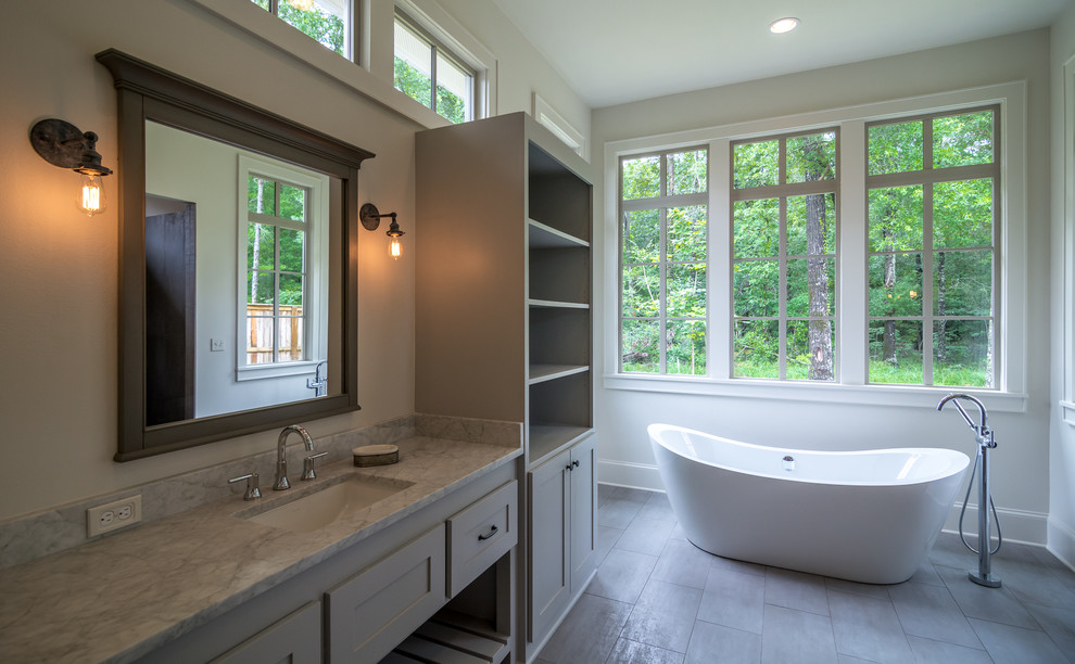 Inspiration for a large country master bathroom in New Orleans with an undermount sink, shaker cabinets, a freestanding tub and an alcove shower.