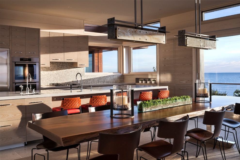 This is an example of a contemporary galley eat-in kitchen in Boston with flat-panel cabinets, medium wood cabinets and stainless steel appliances.