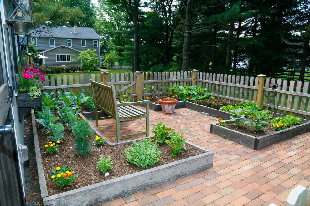 Photo of a mid-sized traditional backyard partial sun garden for summer in Philadelphia with a vegetable garden and brick pavers.