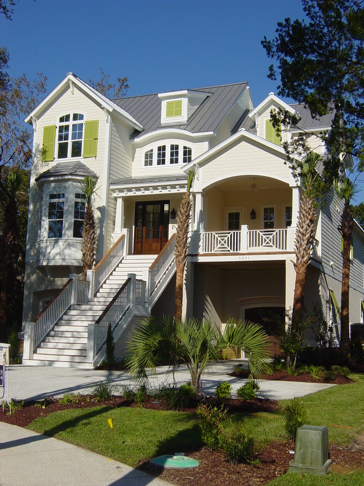 Photo of a mid-sized beach style three-storey white house exterior in Charleston with concrete fiberboard siding, a gable roof and a metal roof.