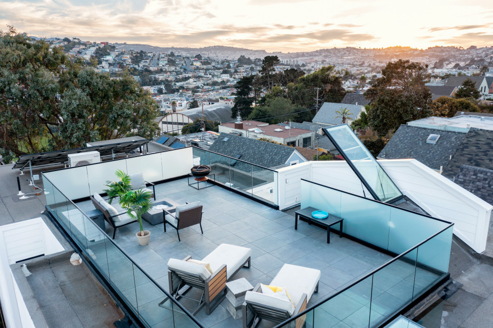 Inspiration for a mid-sized modern rooftop and rooftop deck in San Francisco with a fire feature, no cover and glass railing.