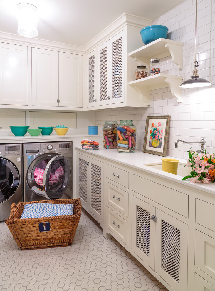 This is an example of a large country l-shaped dedicated laundry room in Los Angeles with an undermount sink, shaker cabinets, white cabinets, quartz benchtops, ceramic floors, a side-by-side washer and dryer, white benchtop, white walls and grey floor.