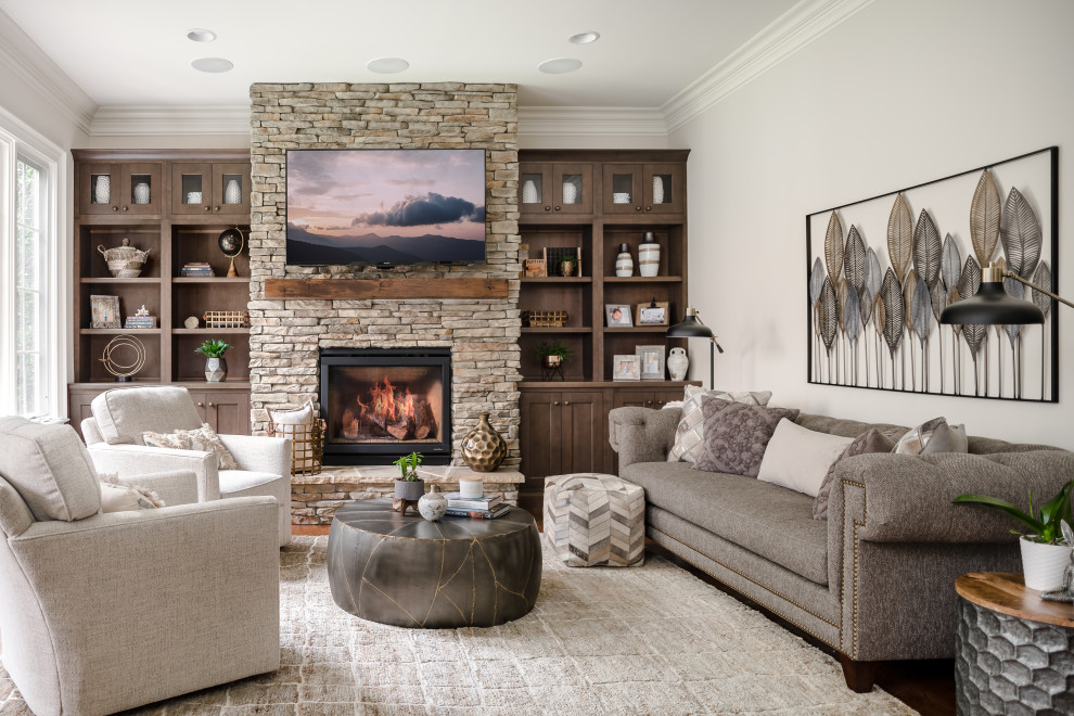 Transitional brown floor and dark wood floor living room photo in Charlotte with gray walls, a standard fireplace, a stacked stone fireplace and a wall-mounted tv