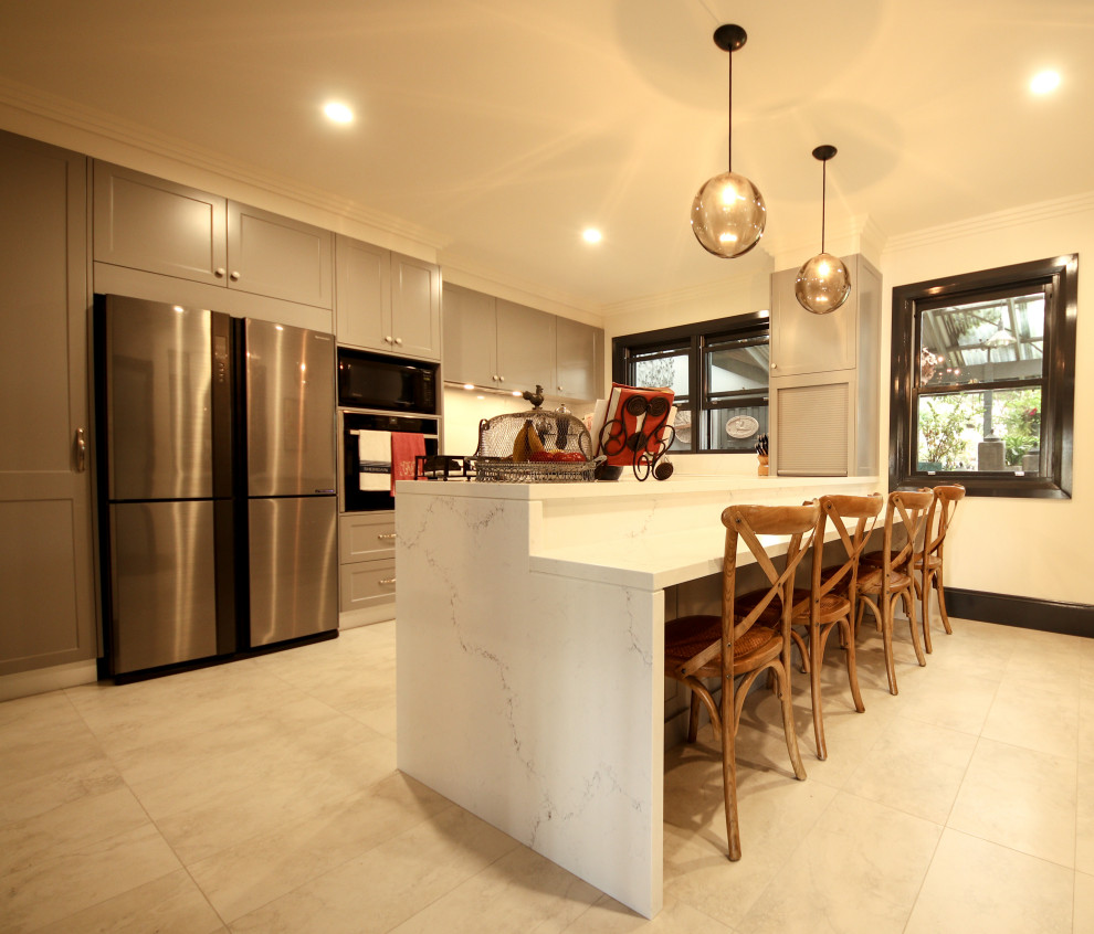 Design ideas for a mid-sized contemporary u-shaped open plan kitchen in Wollongong with a double-bowl sink, shaker cabinets, grey cabinets, quartz benchtops, white splashback, stone slab splashback, black appliances, ceramic floors, no island, beige floor and white benchtop.