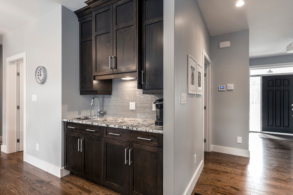 Eat-in kitchen - mid-sized transitional l-shaped dark wood floor eat-in kitchen idea with an undermount sink, shaker cabinets, dark wood cabinets, granite countertops, gray backsplash, glass tile backsplash, stainless steel appliances and an island
