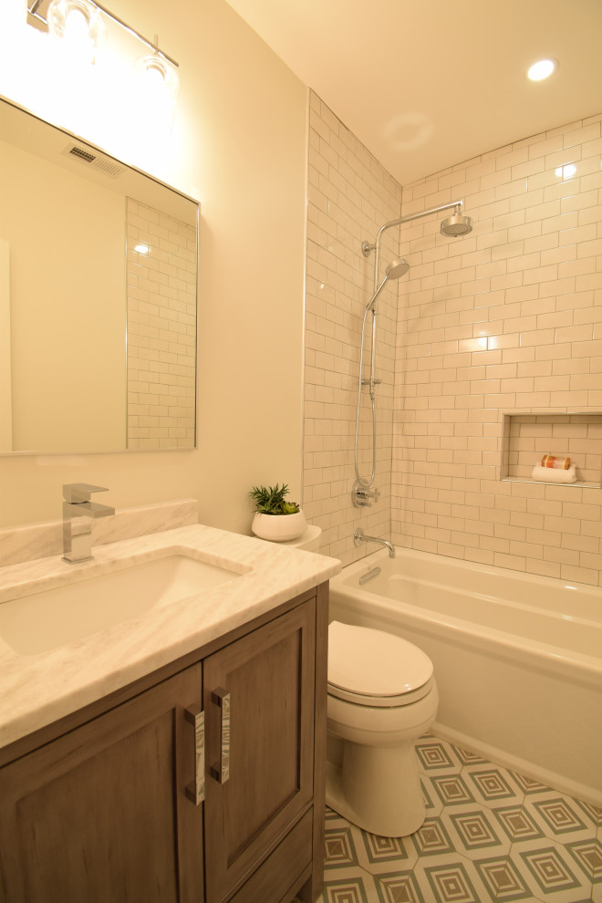 Mid-sized transitional bathroom in DC Metro with shaker cabinets, light wood cabinets, an alcove tub, a shower/bathtub combo, a two-piece toilet, white tile, subway tile, white walls, cement tiles, an undermount sink, granite benchtops, multi-coloured floor, multi-coloured benchtops, a niche, a single vanity and a freestanding vanity.