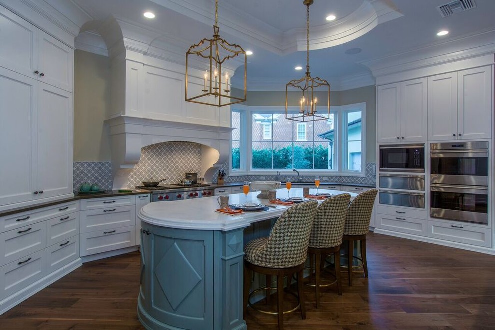 This is an example of a large contemporary l-shaped eat-in kitchen in Tampa with recessed-panel cabinets, white cabinets, marble benchtops, multi-coloured splashback, ceramic splashback, dark hardwood floors and with island.