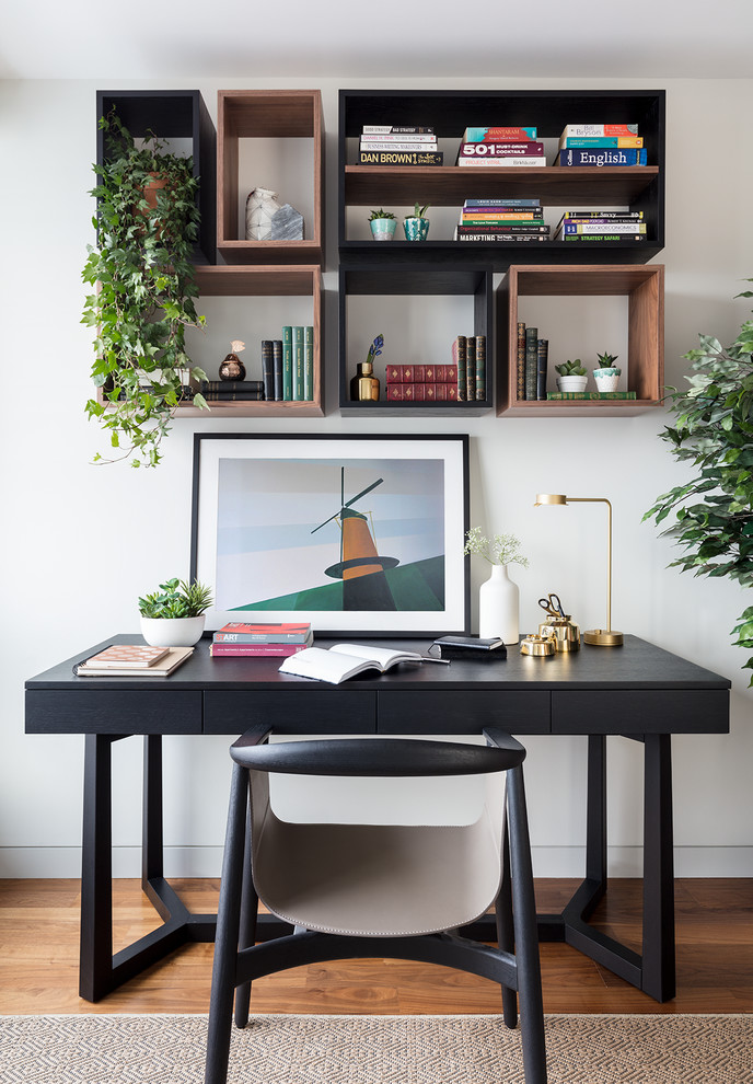 Design ideas for a transitional home office in London with white walls, medium hardwood floors and a freestanding desk.
