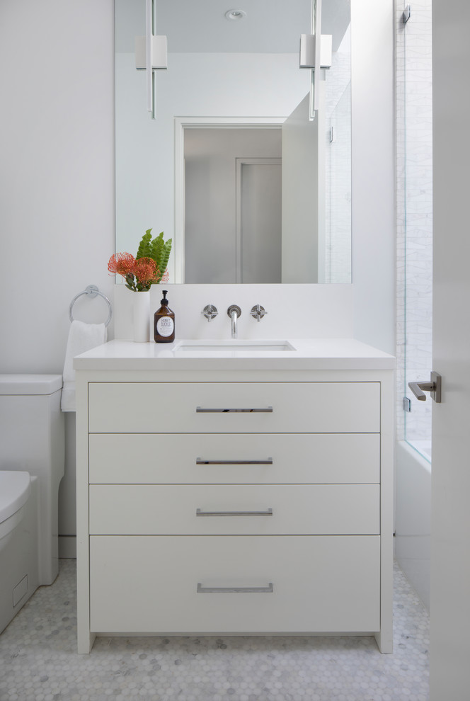 This is an example of a mid-sized contemporary kids bathroom in San Francisco with flat-panel cabinets, white cabinets, white tile, marble, white walls, marble floors, an undermount sink, engineered quartz benchtops, white floor and white benchtops.