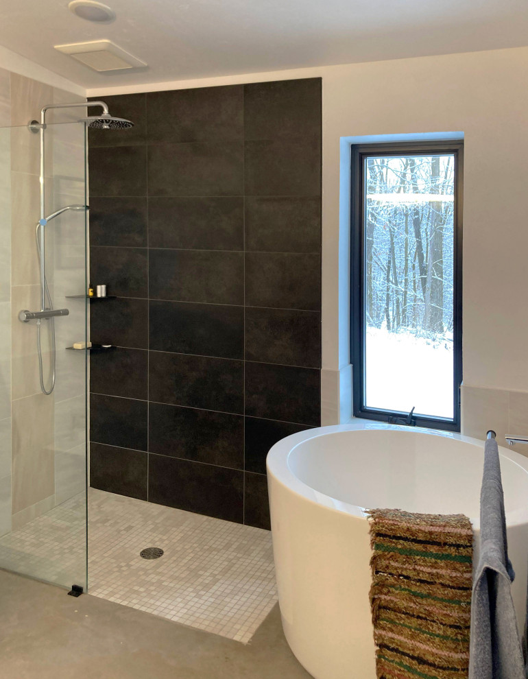 This is an example of a contemporary ensuite bathroom in Other with flat-panel cabinets, light wood cabinets, a japanese bath, a walk-in shower, a bidet, black and white tiles, ceramic tiles, white walls, concrete flooring, a submerged sink, granite worktops, grey floors, an open shower, black worktops, double sinks and a built in vanity unit.
